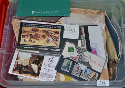 Lot 192 - A plastic container housing a selection of stamps