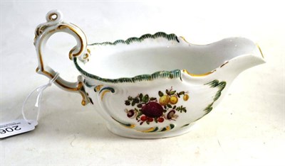 Lot 206 - A gold anchor period Chelsea porcelain sauceboat, circa 1760, with scroll moulded handle and border