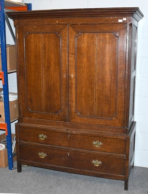 Lot 1239 - A George III Oak Press Cupboard, with fluted...