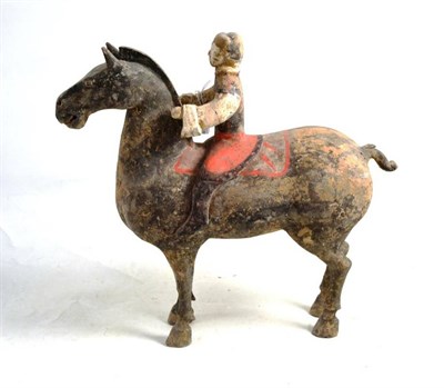 Lot 233 - A Chinese pottery equestrian group, in Tang style, the rider with black jacket and red breeches, on
