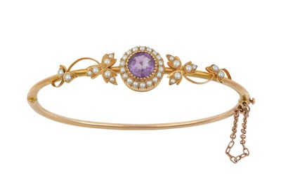 Lot 2391 - An Amethyst and Split Pearl Bangle, circa 1900...