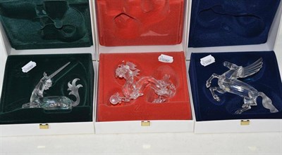 Lot 242 - Three Swarovski boxed ornaments - unicorn, dragon and Pegasus with mirrored stands