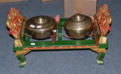 Lot 245 - A Bhutanese carved and giltwood gong stand with two gongs and beaters