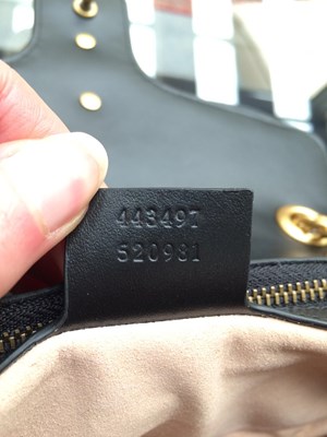 Lot 1025 - A Gucci GG Black Marmont Flap Leather Bag,...