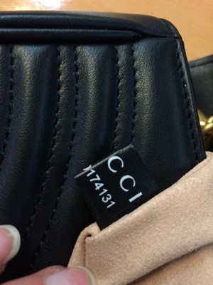 Lot 1025 - A Gucci GG Black Marmont Flap Leather Bag,...