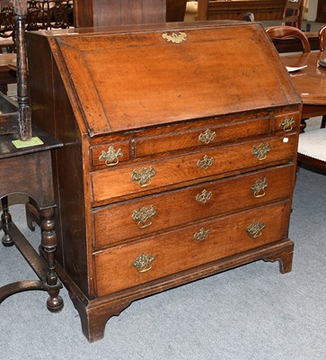 Lot 1257 - A George III Oak Bureau, on three drawer base...