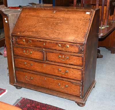 Lot 1246 - A George III Oak Bureau, cross banded in...