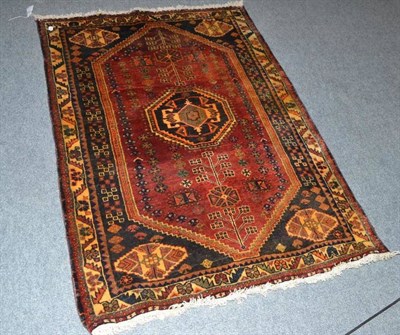 Lot 309 - A red ground rug