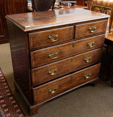Lot 1371 - A George III Crossbanded Oak Chest of Drawers,...