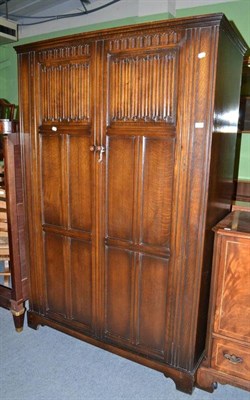 Lot 327 - Oak wardrobe with linen fold decoration