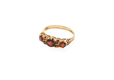 Lot 217 - A 9 Carat Gold Garnet Ring, three graduated...