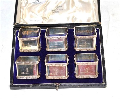 Lot 34 - Walker and Hall six silver napkin rings, numbered 1-6 in a fitted hinged case