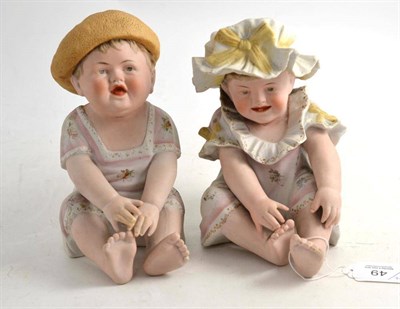 Lot 49 - A pair of bisque piano babies