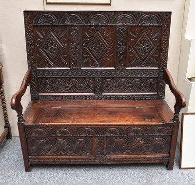 Lot 1151 - A 19th Century Carved Oak Box Settle, with...