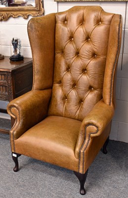 Lot 1118 - A Modern Tan Leather Wing Armchair