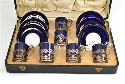 Lot 133 - A Royal Worcester blue and gilt coffee set with silver mounts to the cups in a fitted case