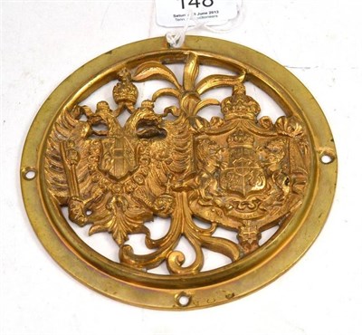 Lot 148 - A copy of a 19th century brass carriage door roundel, pierced and cast with the combined coats...