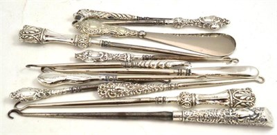 Lot 170 - Eleven assorted silver mounted button hooks and a silver handled shoe horn