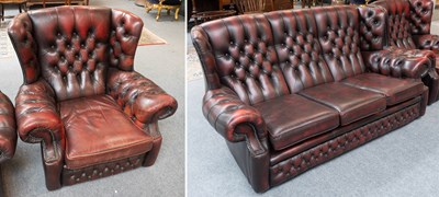 Lot 1213 - An Oxblood Leather Wing Back and Buttoned...