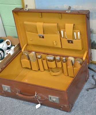 Lot 191 - A leather suitcase, initialled EC, fitted interior and silver-topped jars, 62cm wide