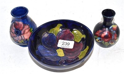 Lot 239 - A Moorcroft Orchid pattern vase, an Anemone and Clematis pattern bowl and vase (3)