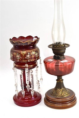 Lot 245 - Oil lamp with cranberry glass oil well, ruby glass lustre with painted decoration (2)