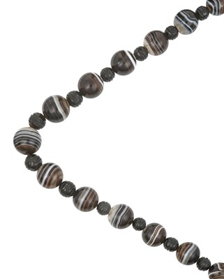 Lot 2348 - A Banded Agate and Jet Beaded Necklace the...