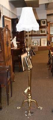 Lot 1379 - An Adjustable Brass Standard Lamp, on four paw...
