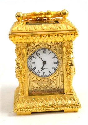 Lot 304 - Gilt metal miniature carriage clock with key