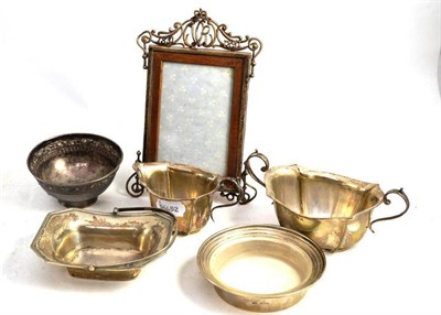 Lot 310 - A small quantity of silver including a sugar bowl, cream jug and photograph frame with dates...