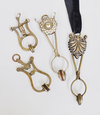 Lot 35 - Two White Metal Ornamental Skirt Lifters, and...