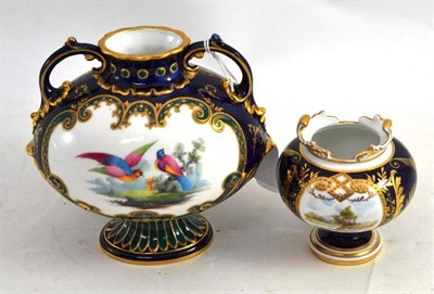 Lot 334 - A Royal Crown Derby two handled blue ground vase painted with birds and a similar smaller vase...