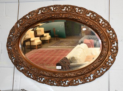 Lot 1376 - A Carved Gilt Wood Oval Mirror, 68cm by 94cm