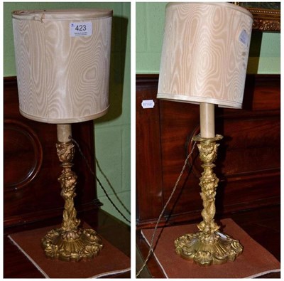 Lot 423 - A pair of gilt metal decorative Rococo style table lamps, with dolphin bases, height 27cm