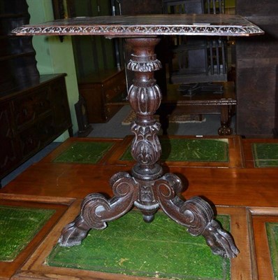 Lot 435 - A 19th century carved oak tripod occasional table