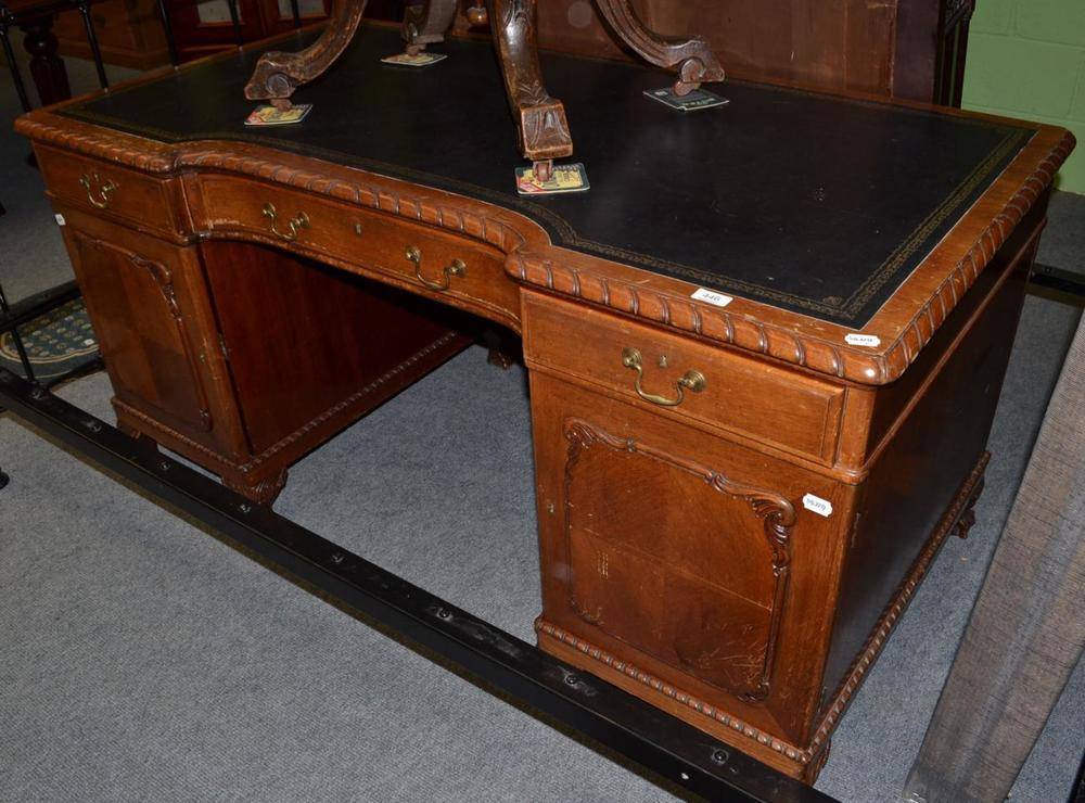 Lot 446 - Mahogany pedestal desk on claw and ball feet with leather top