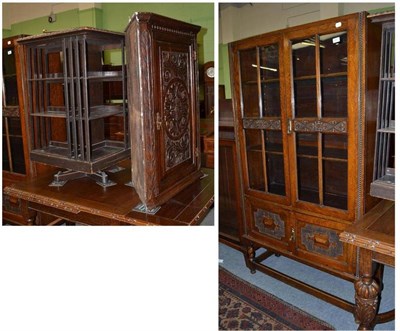 Lot 451 - A carved oak hanging corner cabinet, an oak revolving bookcase and a carved oak glazed display...