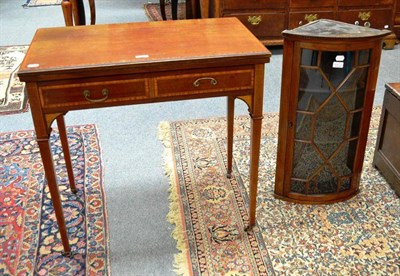 Lot 466 - A small mahogany hanging corner glazed cabinet with bow front and an Edwardian inlaid folding games