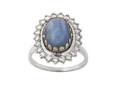Lot 2302 - A Star Sapphire and Diamond Cluster Ring the...