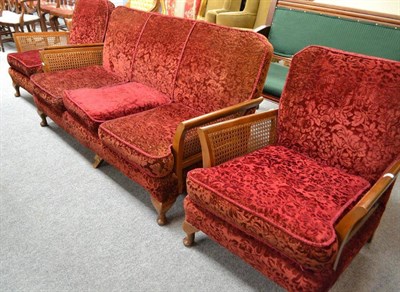 Lot 487 - A 20th century three piece bergere suite with upholstered backs and seats