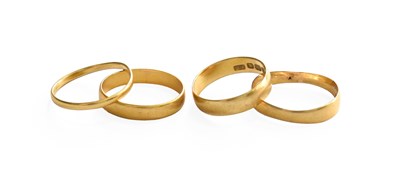 Lot 304 - Three 22 Carat Gold Band Rings, finger sizes K,...