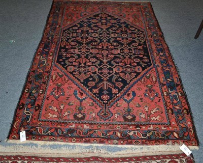 Lot 494 - Malayir Rug, West Persia, the indigo stepped lozenge field of stylised plants enclosed by candy...