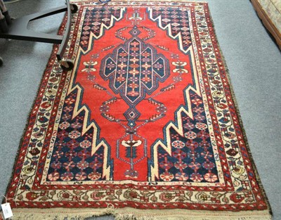 Lot 495 - Mazlaghan Rug, West Persia, the blood red field of lightning design enclosing by spandrels and...