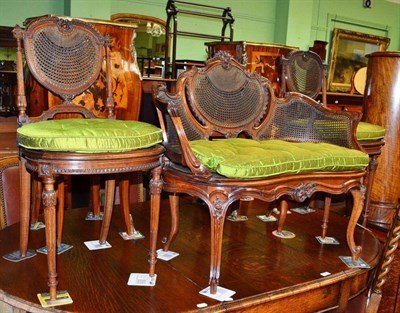 Lot 537 - A walnut and cane small settee and two side chairs