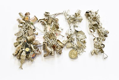 Lot 390 - Four Silver/White Metal Charm Bracelets, the...