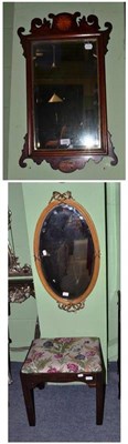 Lot 559 - A mahogany inlaid fret carved wall mirror, an oval wall mirror and a mahogany footstool