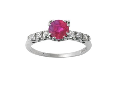 Lot 2269 - A Synthetic Ruby and Diamond Ring the central...