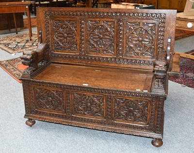 Lot 1262 - 1920s Carved Oak Monks Bench, with lion form...