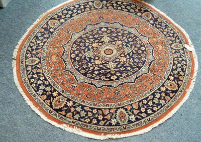 Lot 589 - An unusual circular rug, probably Tabriz, Persian Azerbaijan, the mid blue medallion of...