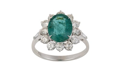 Lot 2037 - An Emerald and Diamond Cluster Ring the oval...